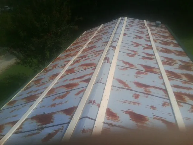 Rusted metal roof panels with new wood purlins before replacement — Storm Damage Roof Repair in Point Reyes Station by Roofing Brothers