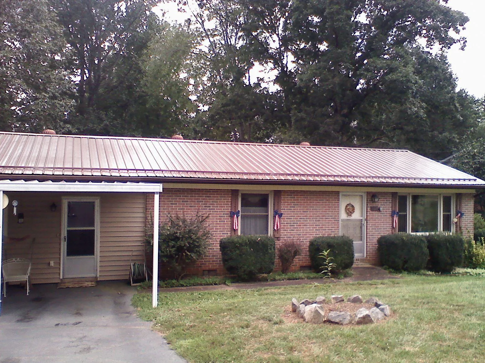 Bronze metal roof and carport on a brick ranch home — Roof Repair work by our crew in Point Reyes Station